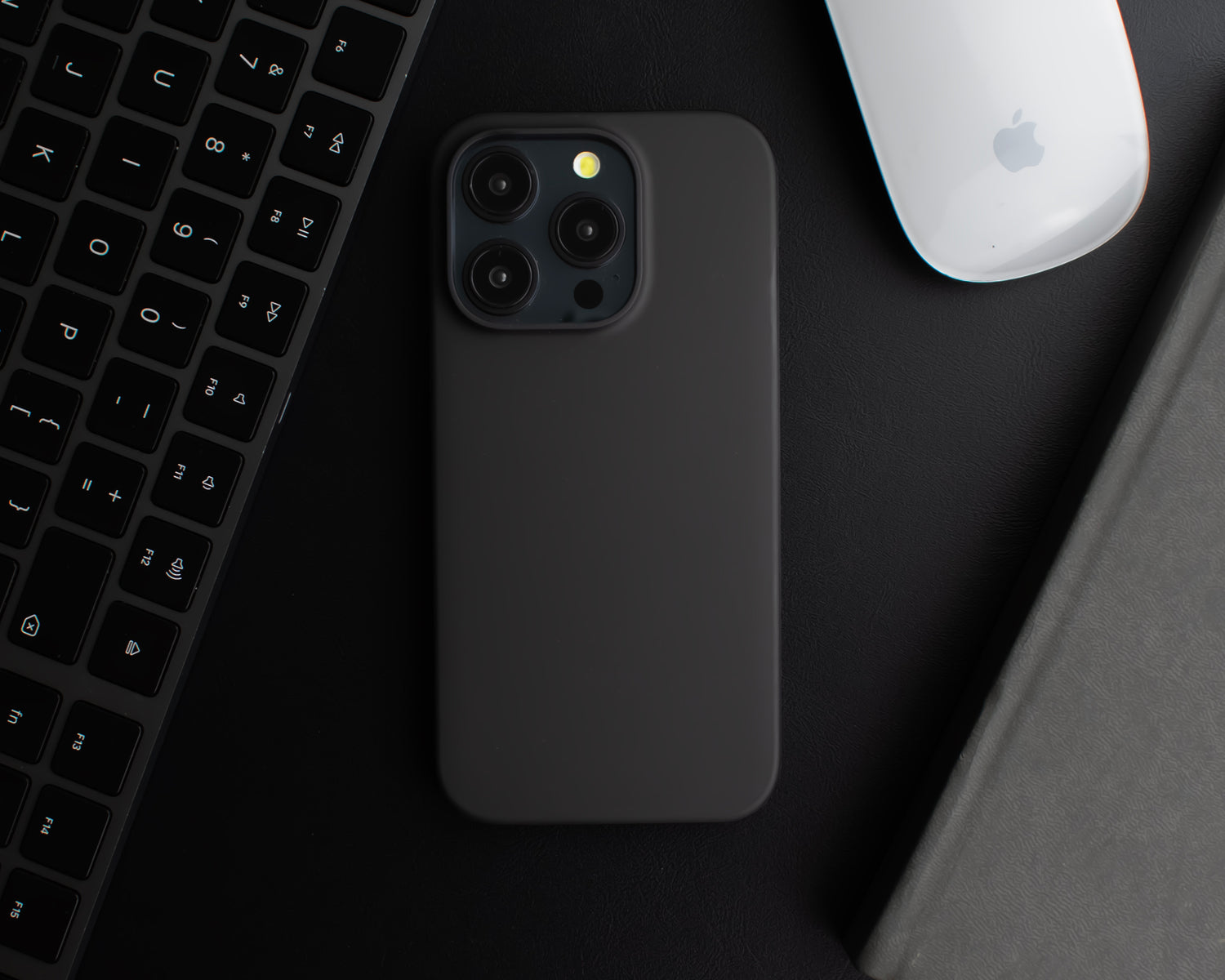 The Black SKNS THIN Magnetic Case fitted to iPhone 15 Pro on a black desk highlighting the ultra thin design