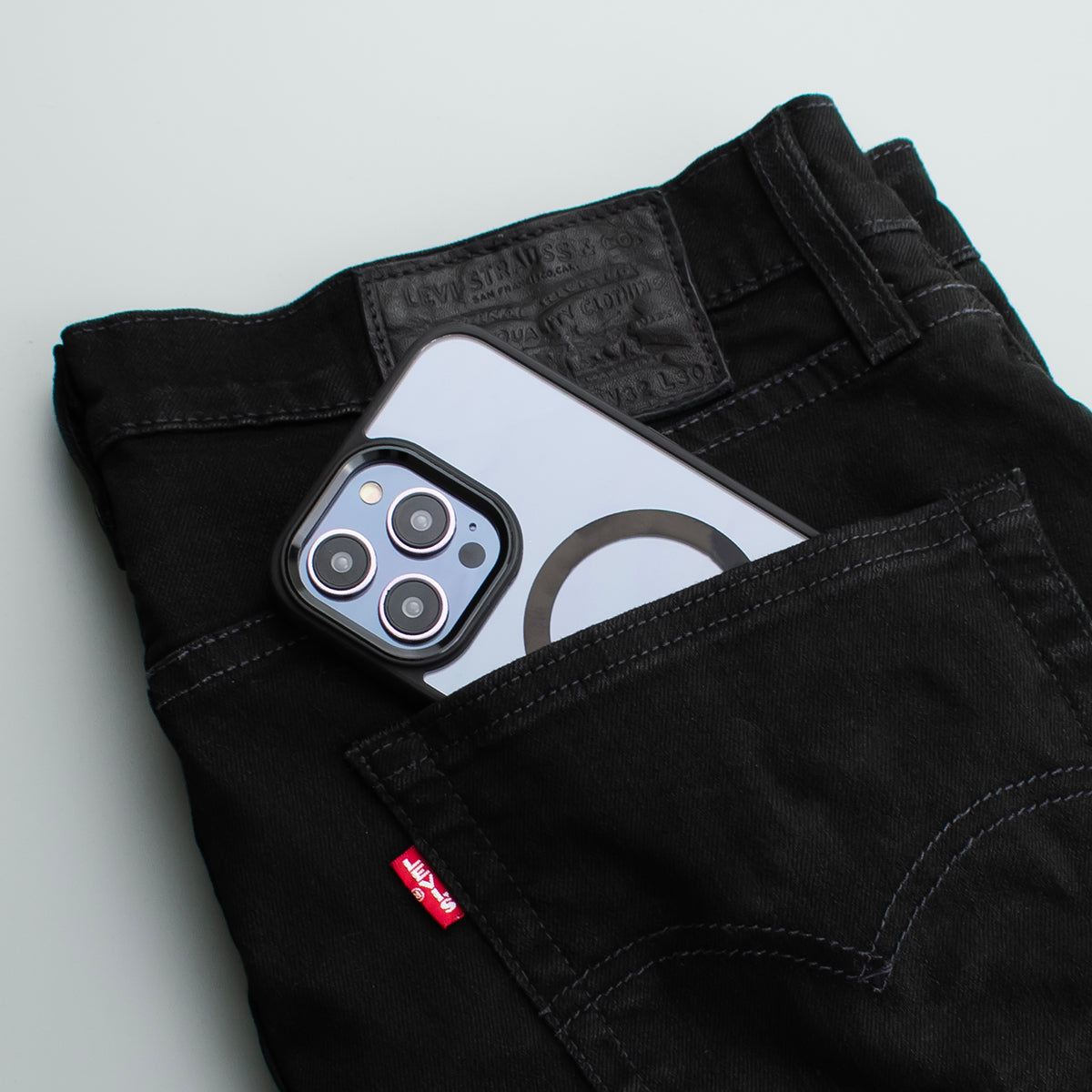 Lifestyle image of the SKNS SHOCK case fitted to the iPhone 14 Pro Max in a pair of jeans showing the real world shockproof protection