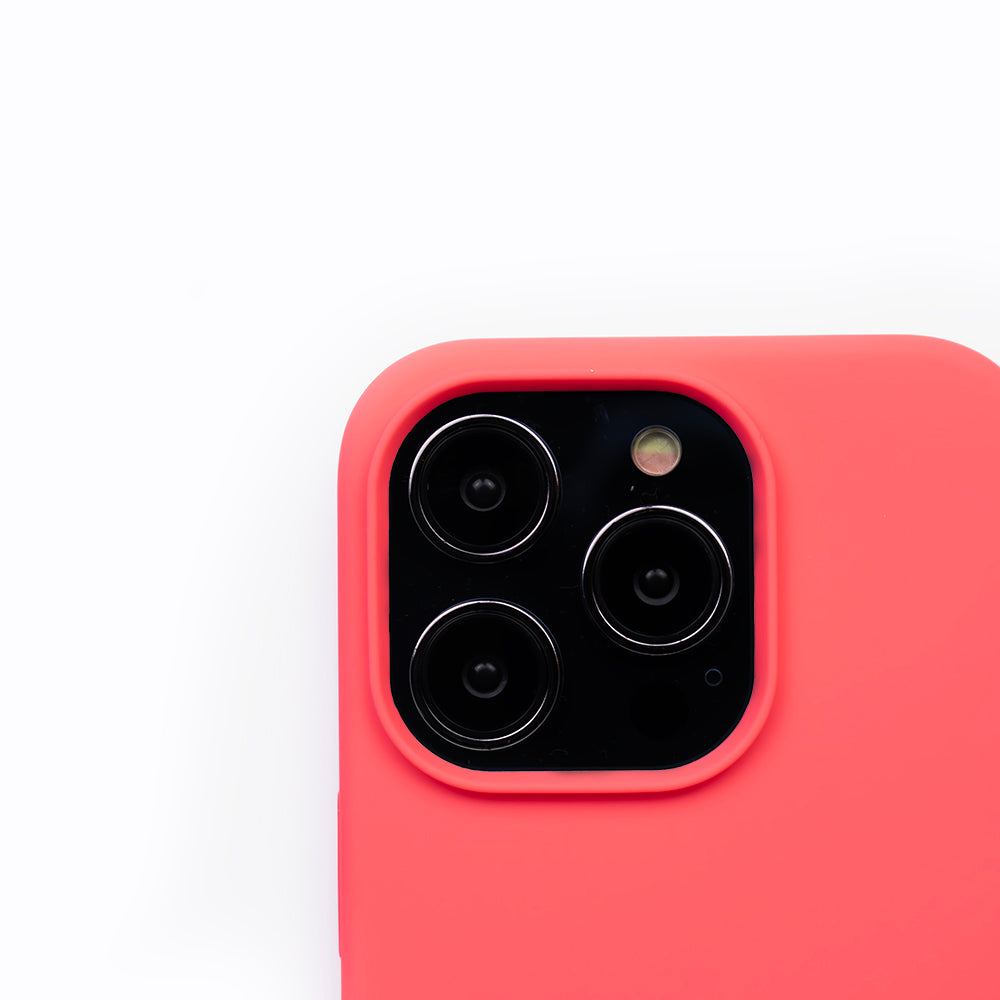 Close up image of the SKNS SILICONE case in Blood Orange on the iPhone 14 Pro Max showcasing the cameras raised lip