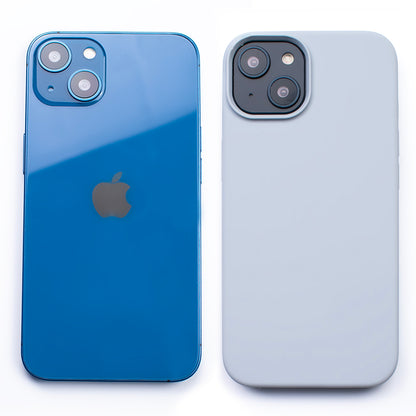 Side by side back image of the SKNS SILICONE Soft & Protective Powder Blue Case fitted to the iPhone 14 Plus next to a plain iPhone highlighting the Protective slim design