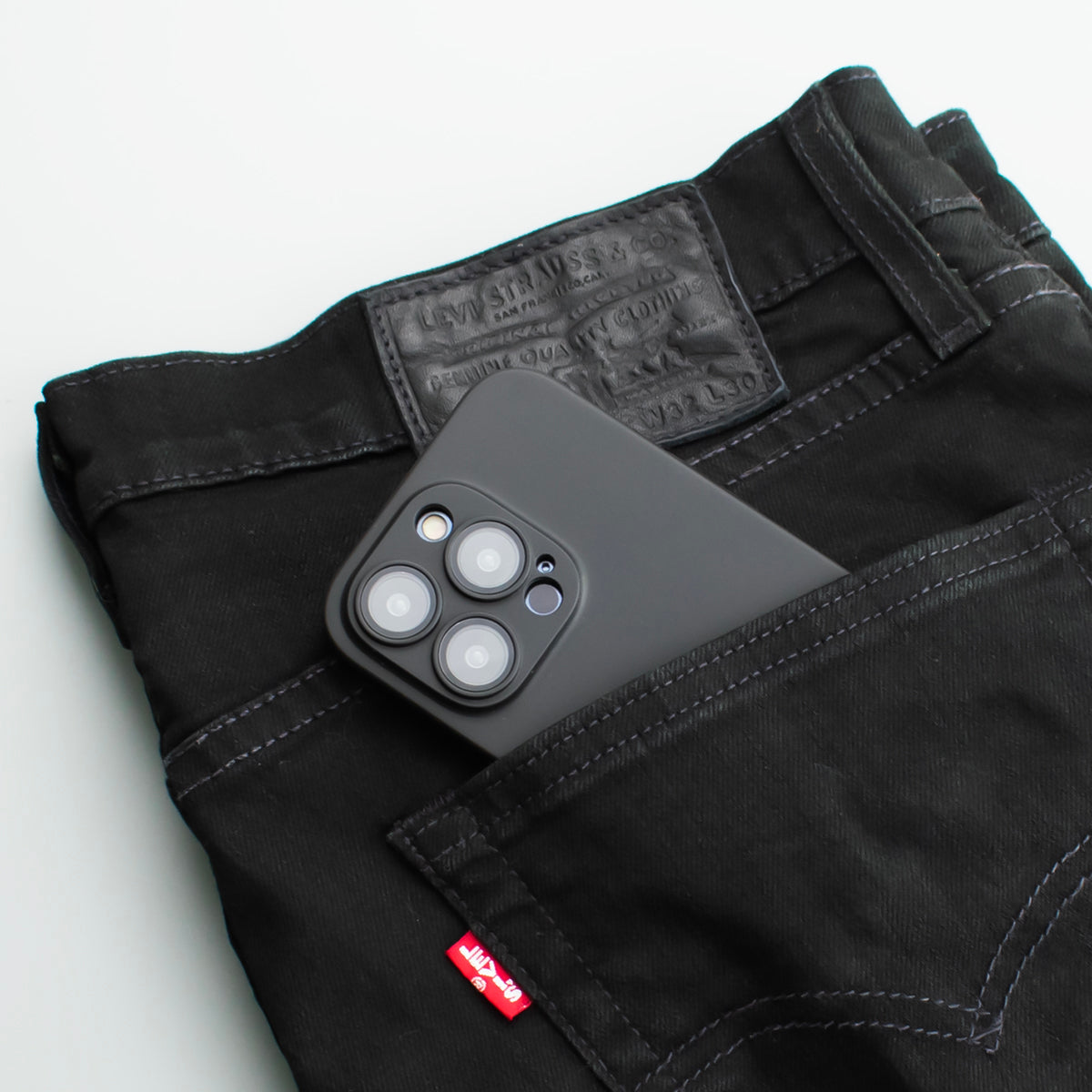 Lifestyle image of SKNS THIN v2 on iPhone 14/13 Pro Max in backpocket of jeans showcasing the protective elements of the case