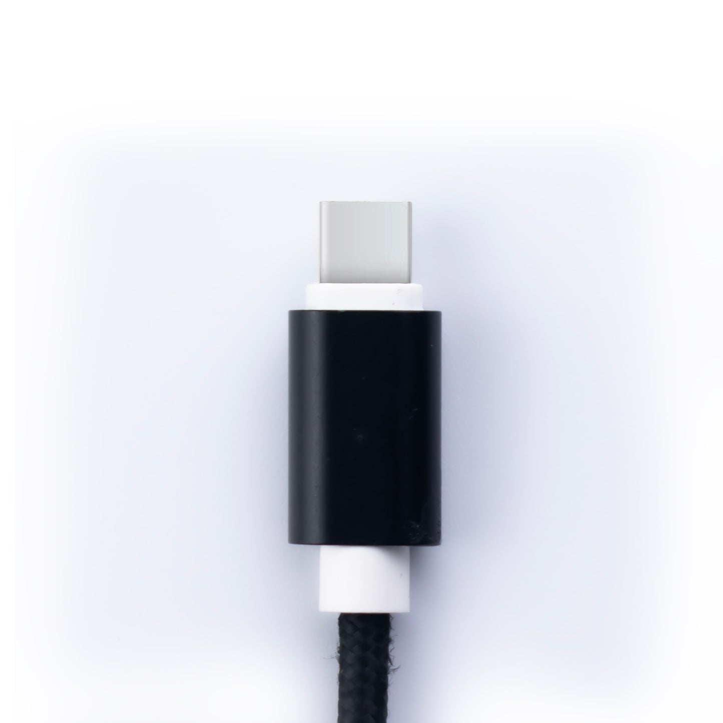 Close up image of the USB C SKNS Nylon braided cable showing the black metal and plastic cable protector